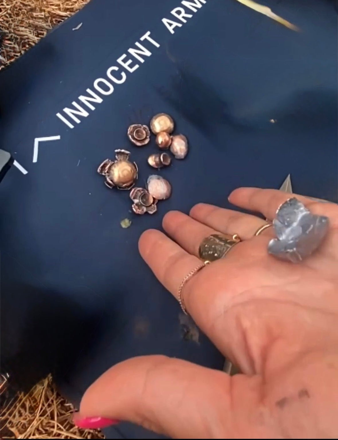 Recovered handgun bullets on an Innocent Armor ShieldTec soft body armor panel after independent ballistic testing